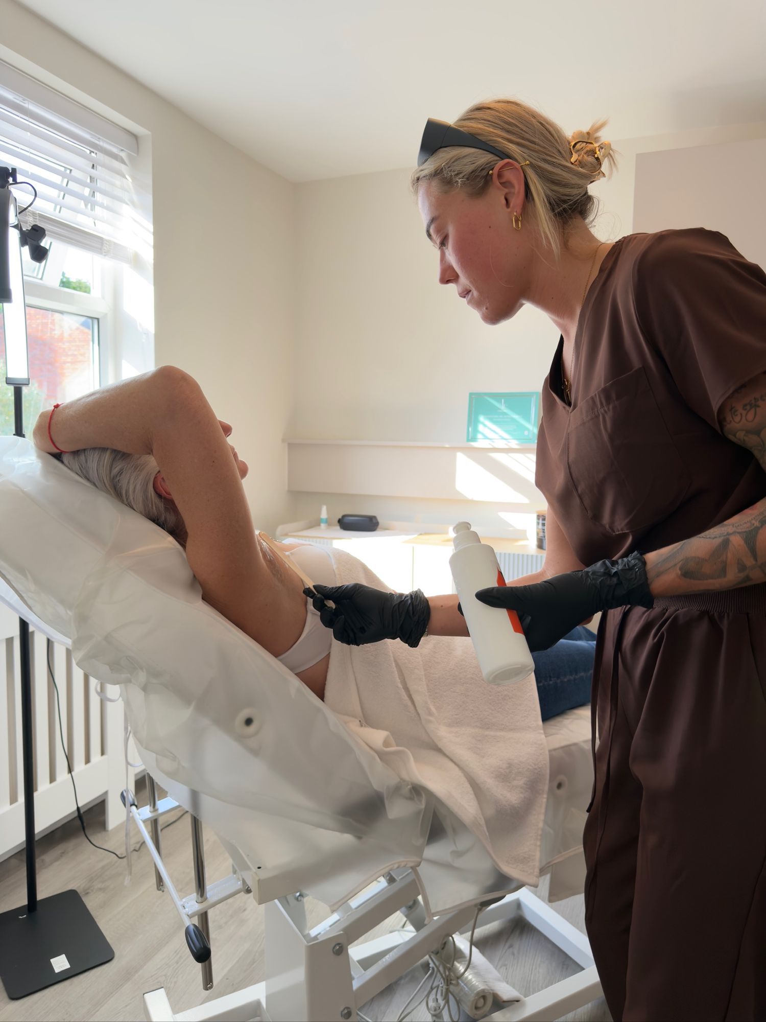 Laser hair removal treatment being performed on the underarm
